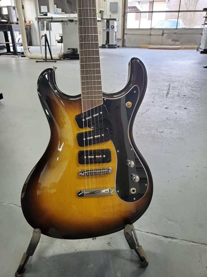Close up of the body of the sunburst Mosrite style guitar with three P-90 pickups