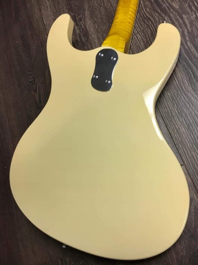 Back of a vintage white Mosrite style guitar