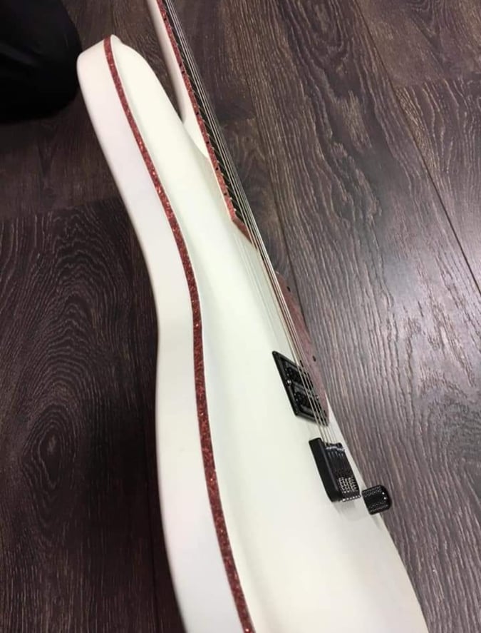 Sparkle pink binding on a white guitar body
